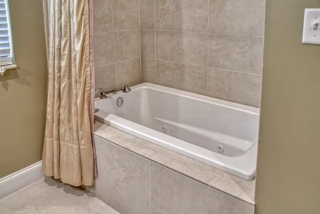a bath tub sitting next to a white sink