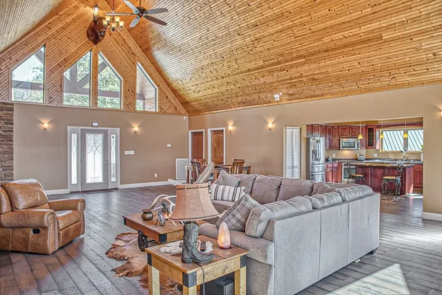 a living room with furniture a flat screen tv and a table