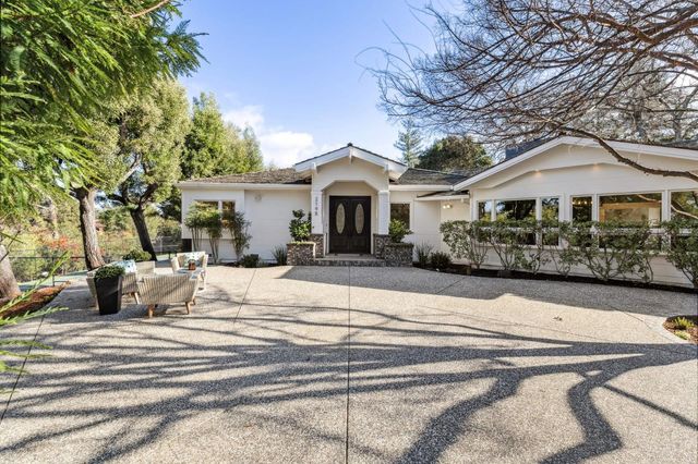 a view of a yard with wooden fence
