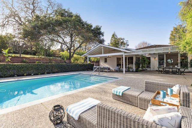 a front view of a house with a sitting area