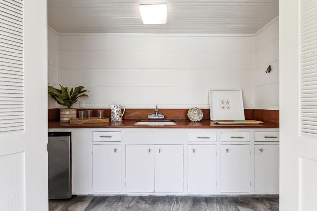 a view of a house with swimming pool and sitting area