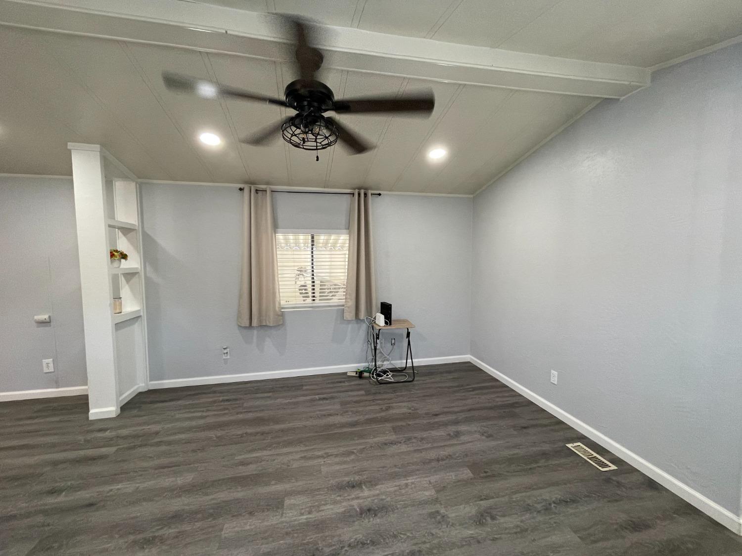 2110 Helm Avenue, Unit 16 Clovis, CA 93612 - Photo 18 of 31 wooden floor in an empty room with a window