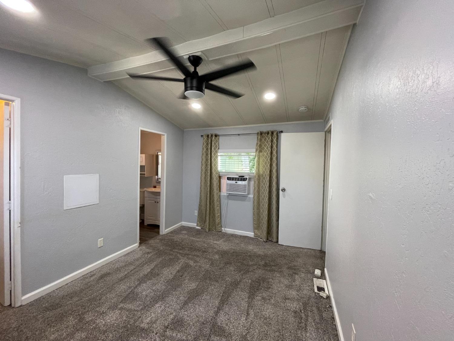 2110 Helm Avenue, Unit 16 Clovis, CA 93612 - Photo 24 of 31 a view of a livingroom with a ceiling fan and window