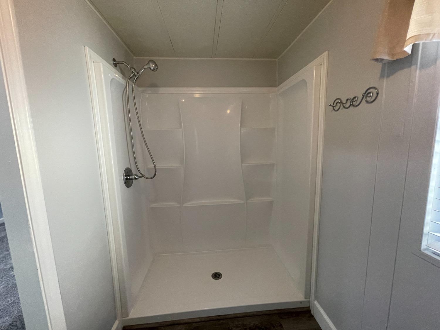 2110 Helm Avenue, Unit 16 Clovis, CA 93612 - Photo 28 of 31 a bathroom with a glass door shower