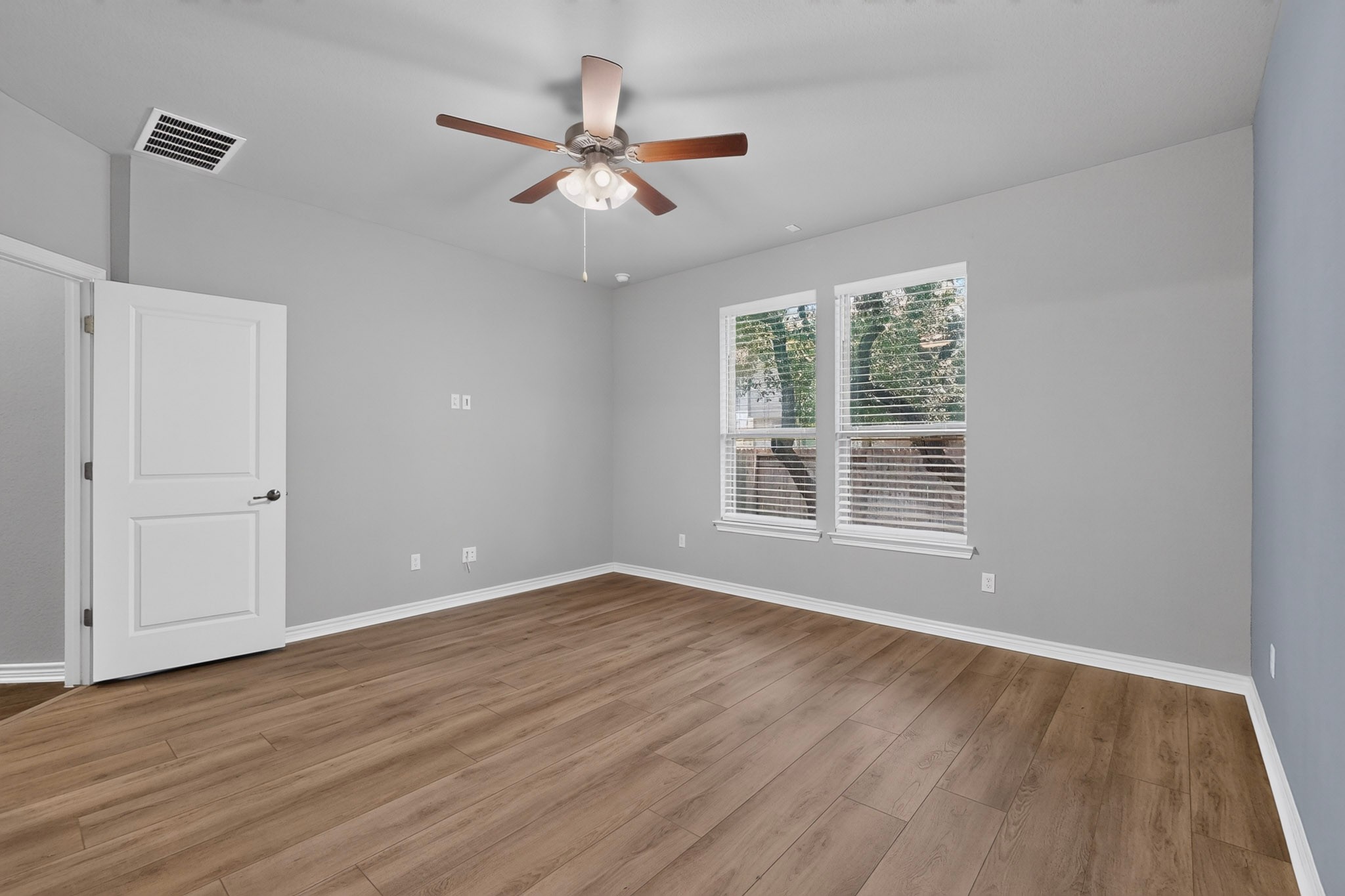 1908 Turtle Bay Loop Leander, TX 78641 - Photo 16 of 38 A versatile room featuring wide plank flooring, dual windows, and an overhead fan.