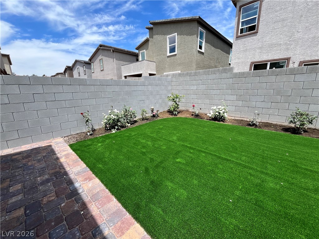 8336 Rowan Rdg Avenue Las Vegas, NV 89147 - Photo 15 of 15 This spacious private yard features vibrant green artificial turf and a neatly paved patio.