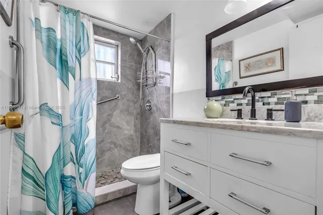 a bathroom with a toilet sink and shower