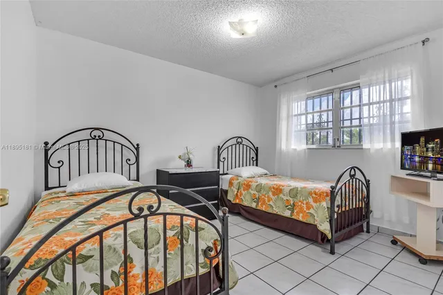 a bedroom with two beds and a window