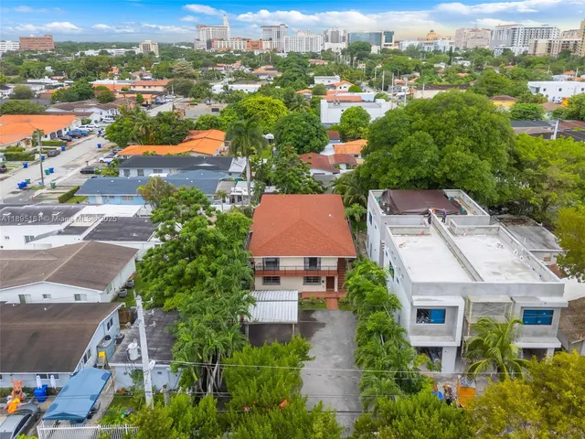 an aerial view of residential houses with outdoor space