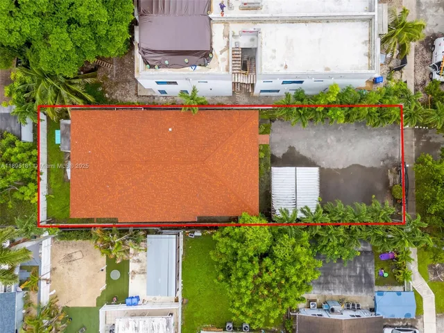 an aerial view of a house with a yard and a fountain