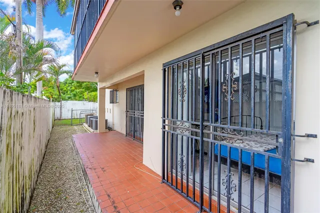a view of a backyard with wooden fence