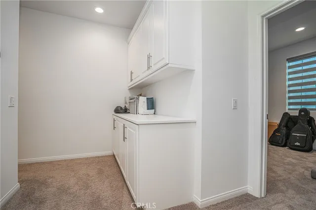 a view of storage and utility room with closet