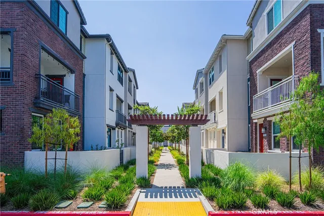 a front view of a multi story building with yard