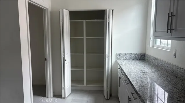a bathroom with a granite countertop sink a vanity and a blue