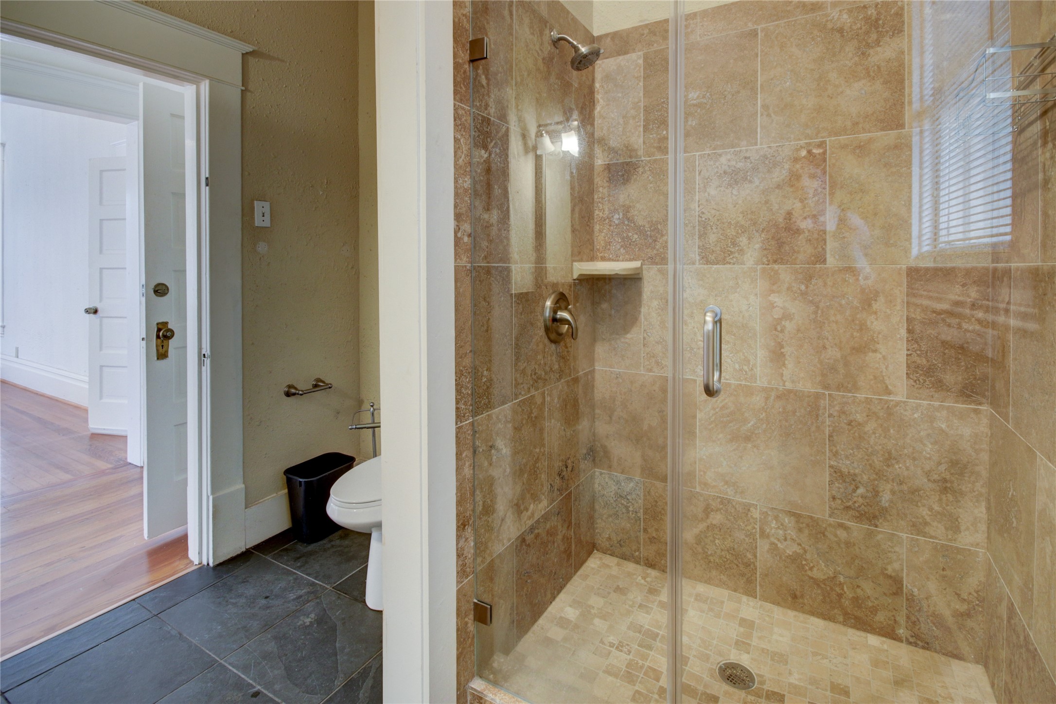 239 Westheimer Road Houston, TX 77006 - Photo 32 of 50 SECOND FLOOR:The full bathroom features a sleek standing shower with a custom tile backsplash and a seamless glass enclosure, creating a modern, spa-like experience.