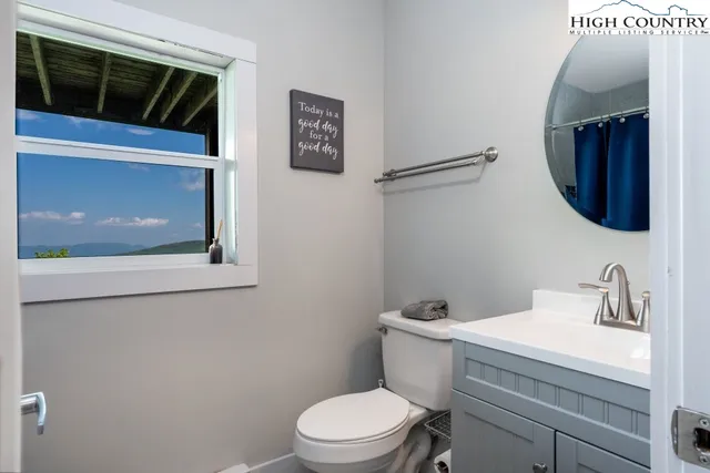 a bathroom with a toilet a sink and mirror