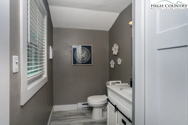 a bathroom with a toilet a sink and a window