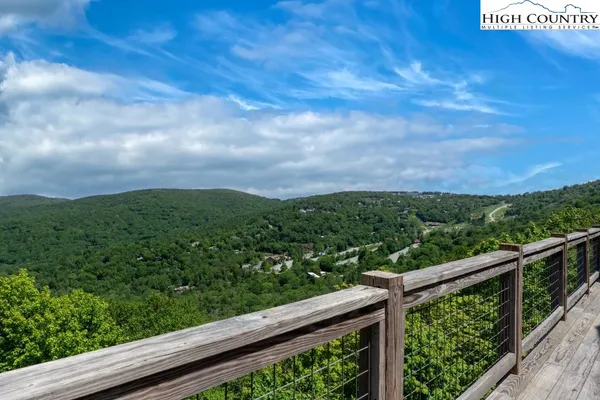 a view of a forest from a balcony