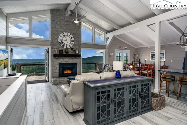 a living room with furniture a fireplace and a table