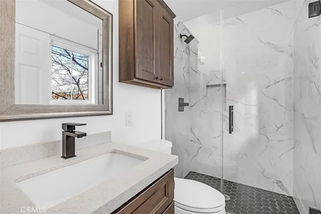 a bathroom with a sink toilet and shower
