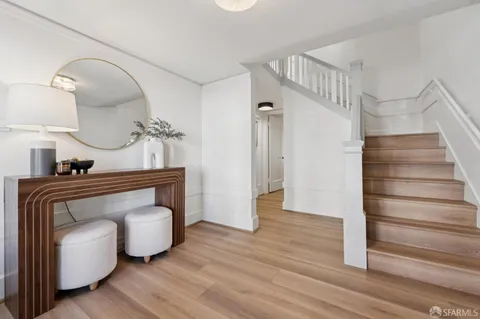 a living room with furniture a fireplace and a chandelier