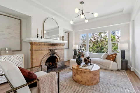 a living room with furniture and a chandelier