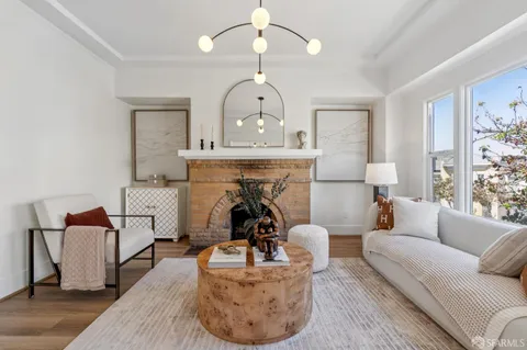a kitchen with a table chairs refrigerator and cabinets