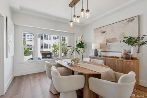 a view of a dining room with furniture and a potted plant