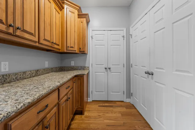 a kitchen with stainless steel appliances granite countertop a sink and dishwasher with wooden cabinets