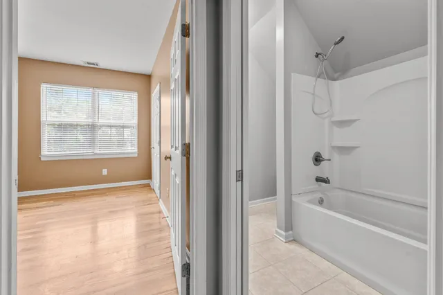 a bathroom with a bathtub and a shower