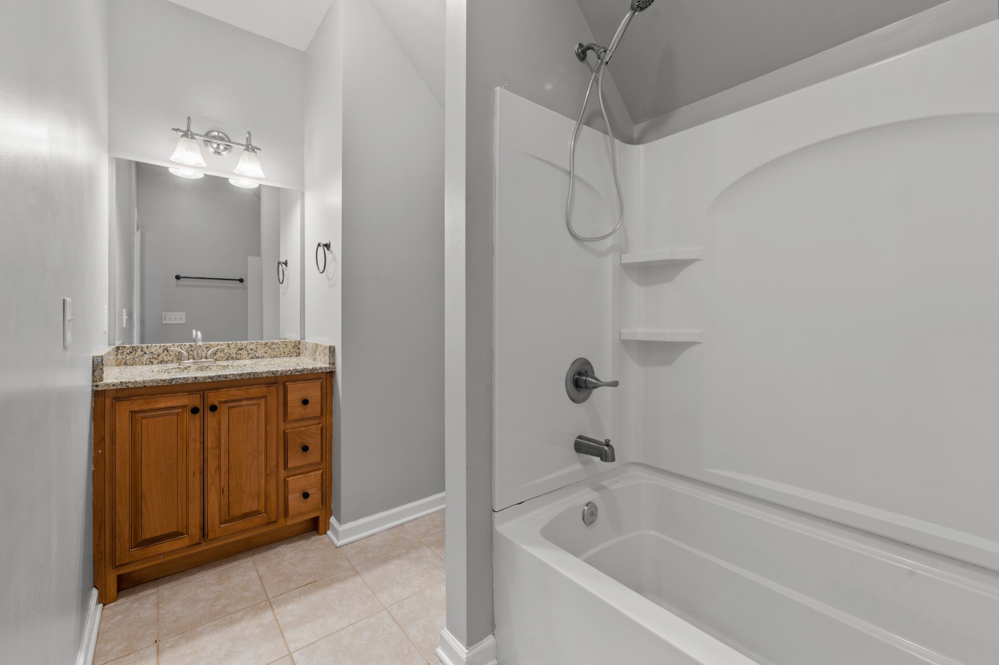 114 Cartwright Parkway Goodlettsville, TN 37072 - Photo 26 of 34 a bathroom with a granite countertop sink a mirror and a bathtub