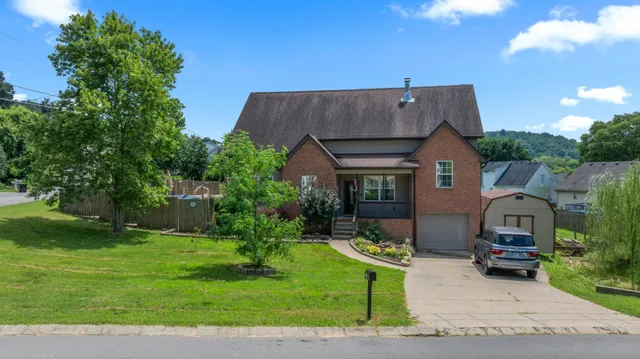 a front view of house with a garden and patio