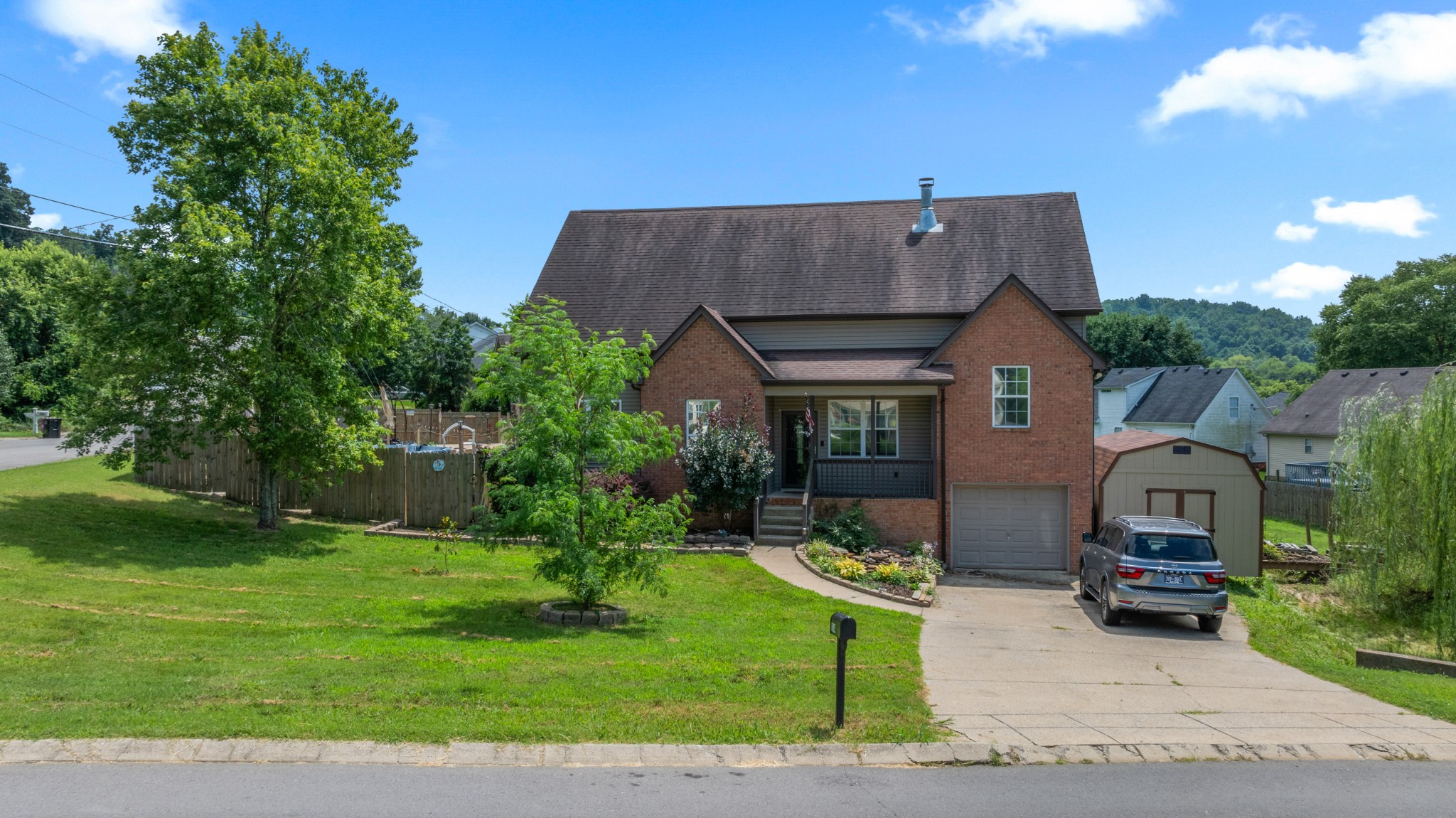 114 Cartwright Parkway Goodlettsville, TN 37072 - Photo 3 of 34 a front view of house with a garden and patio