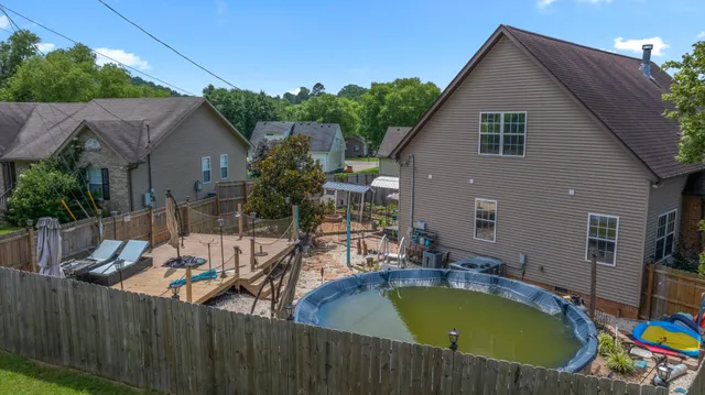 a view of a house with pool and chairs