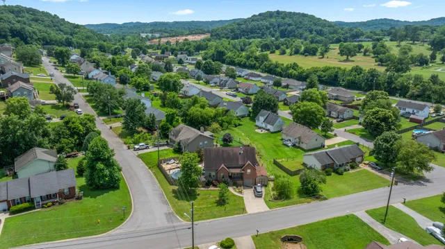 an aerial view of a house with yard
