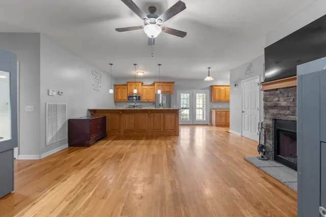 a view of a kitchen with a sink and a fireplace