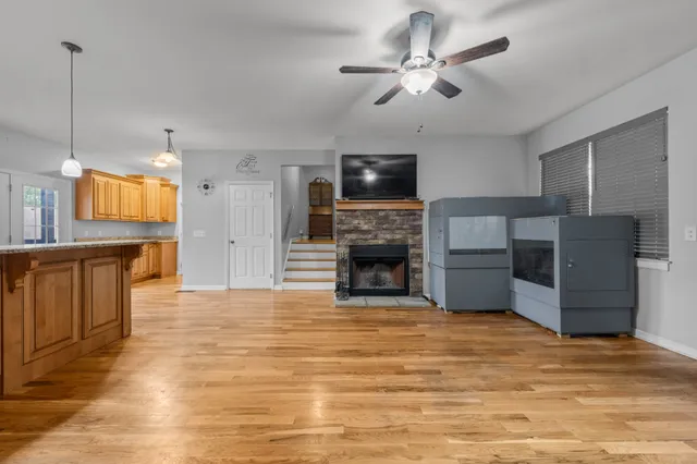a view of kitchen with granite countertop cabinets and refrigerator