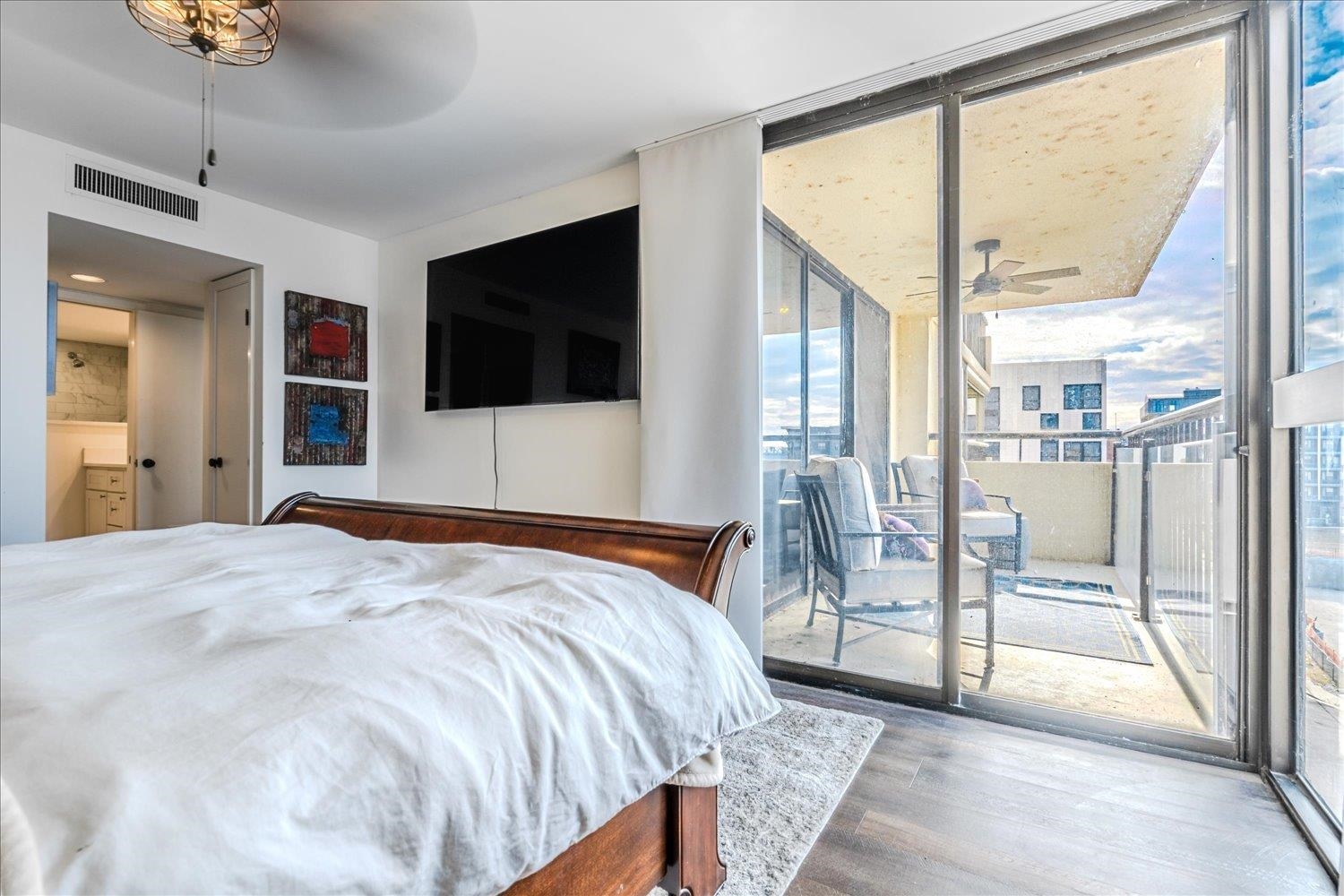 200 Wagner Place, Unit 706 Memphis, TN 38103 - Photo 14 of 32 a bedroom with a large bed and a flat tv screen on dresser