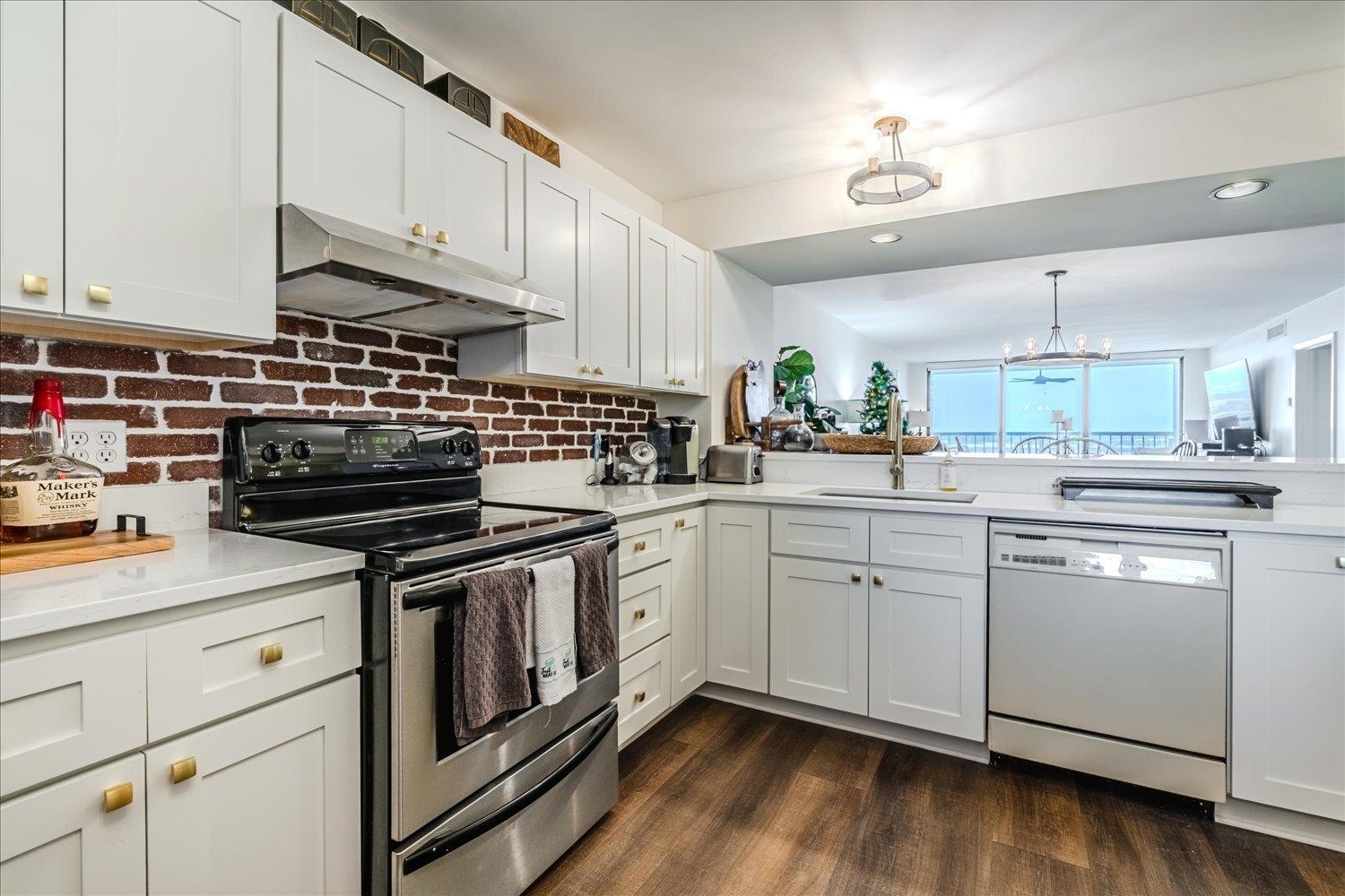 200 Wagner Place, Unit 706 Memphis, TN 38103 - Photo 6 of 32 a kitchen with cabinets stainless steel appliances and wooden floor