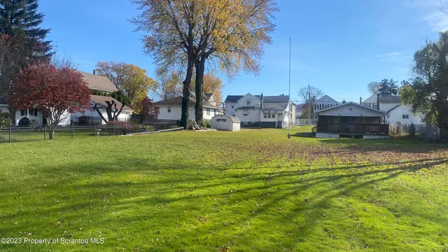 a swimming pool with trees in front of it