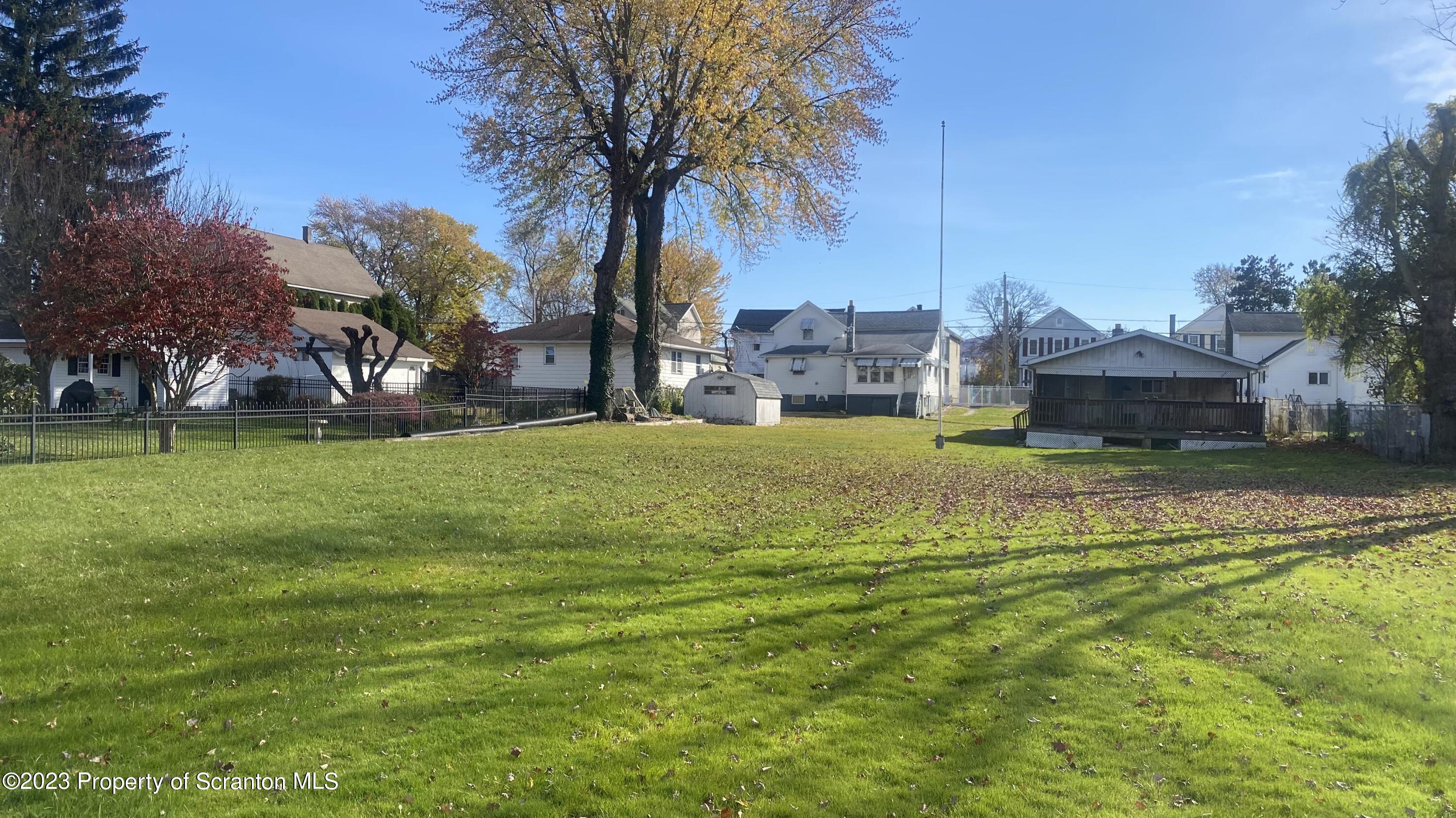 a swimming pool with trees in front of it