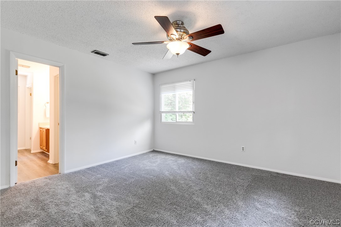 2655 Ridge Road Powhatan, VA 23139 - Photo 12 of 25 an empty room with windows and fan