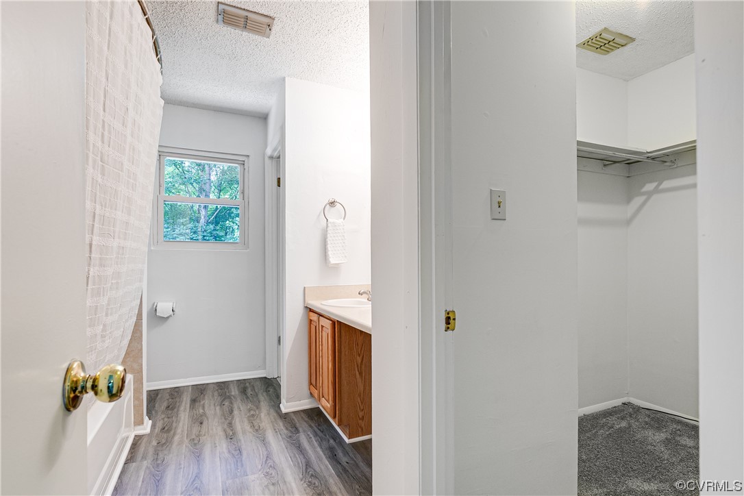 2655 Ridge Road Powhatan, VA 23139 - Photo 14 of 25 a view of hallway with walk in closet and wooden floor