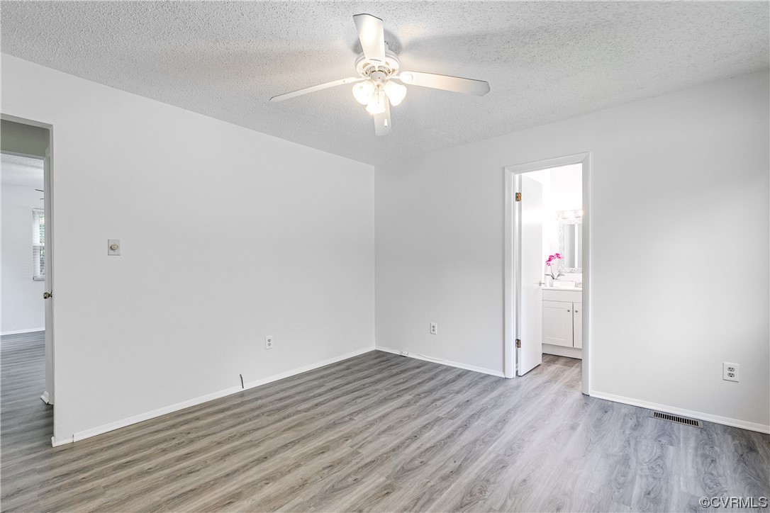 2655 Ridge Road Powhatan, VA 23139 - Photo 10 of 25 an empty room with wooden floor and fan