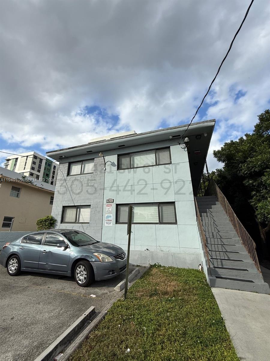 a front view of a house with parking space