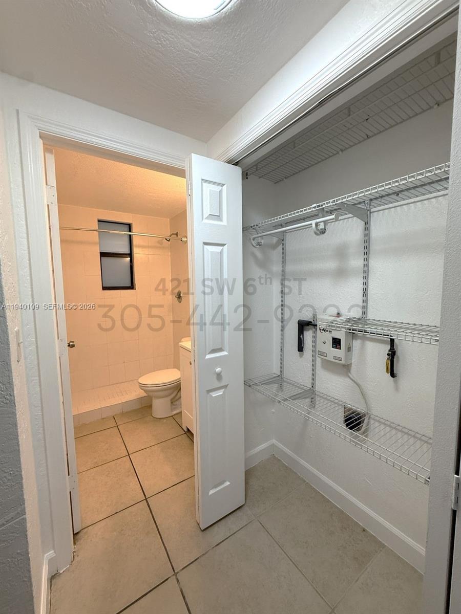421 Southwest 6th Street, Unit 9 Miami, FL 33130 - Photo 5 of 9 a bathroom with a glass door shower