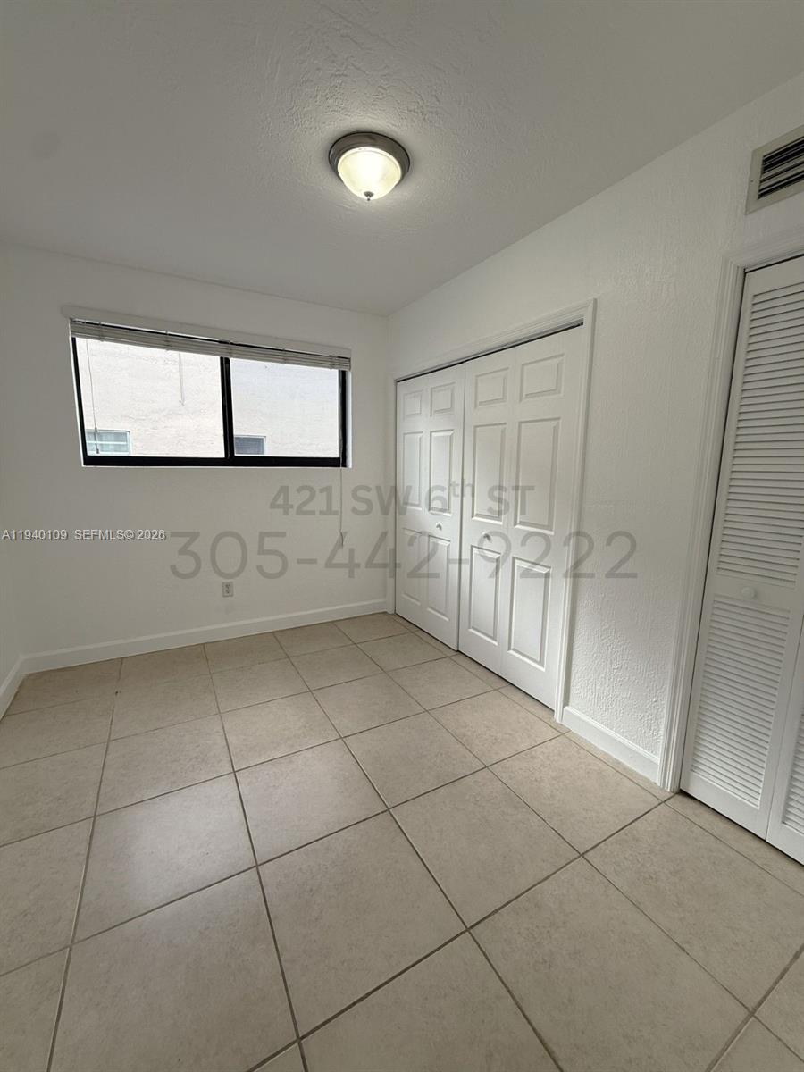 421 Southwest 6th Street, Unit 9 Miami, FL 33130 - Photo 6 of 9 a view of an empty room and window