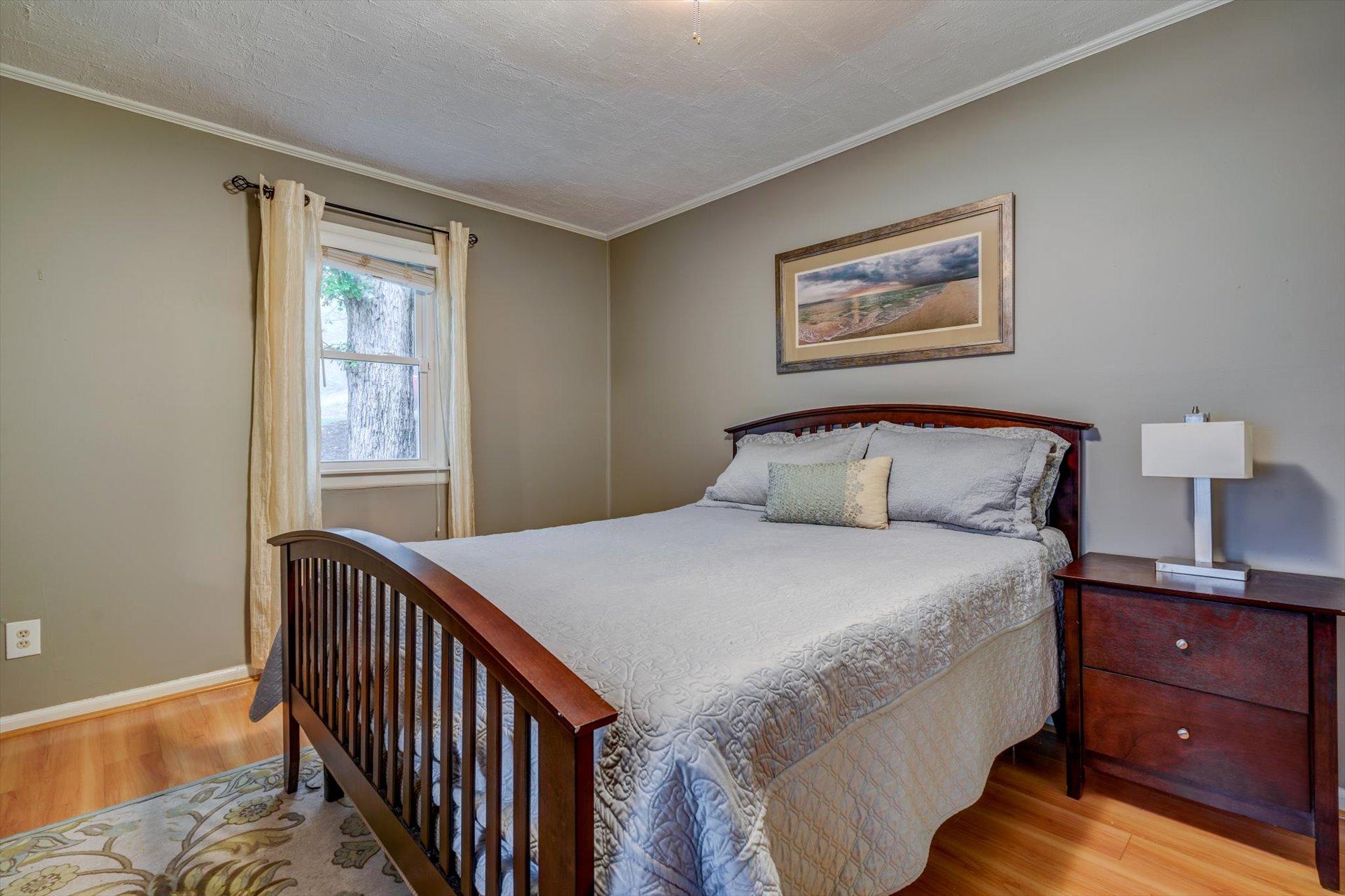 772 Skyview Road Salem, VA 24153 - Photo 17 of 41 a bedroom with a bed and wooden floor