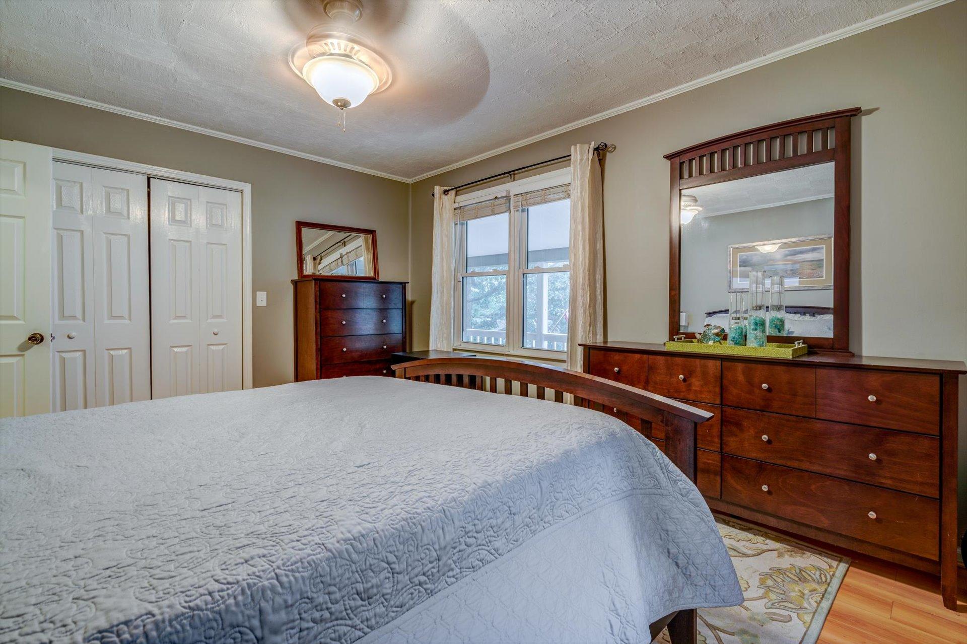 772 Skyview Road Salem, VA 24153 - Photo 18 of 41 a bedroom with a bed and a dresser with mirror