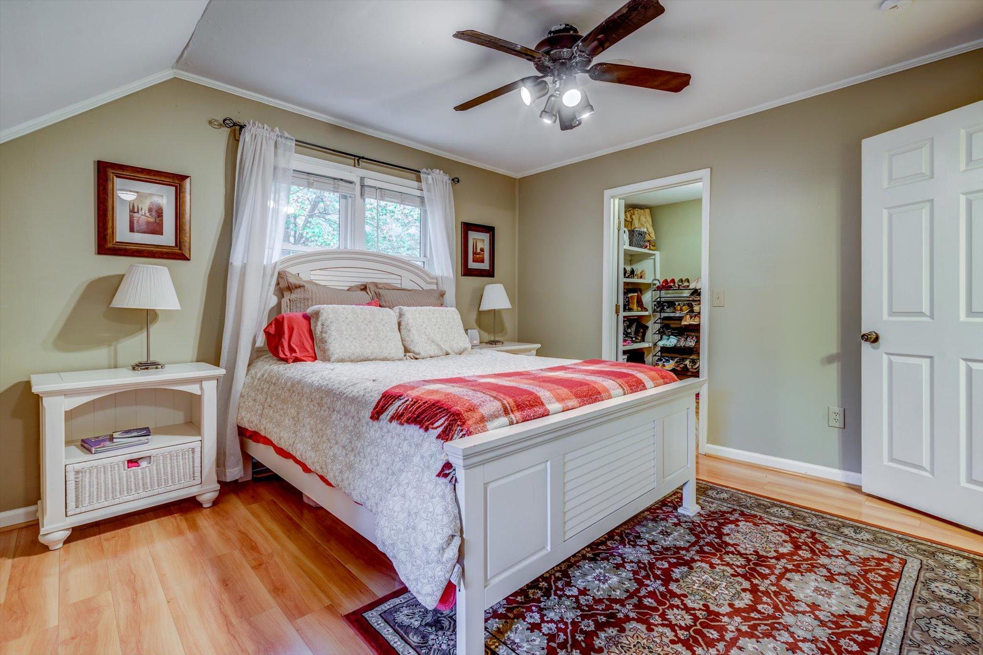 772 Skyview Road Salem, VA 24153 - Photo 19 of 41 a bedroom with a bed and a chandelier